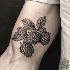 a black and white tattoo with raspberries on the leg