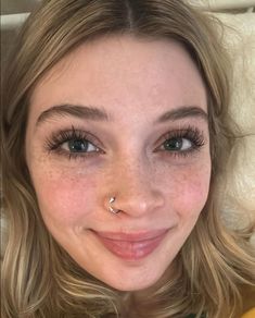 a close up of a person with freckles on her nose