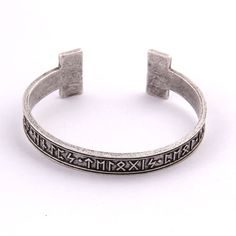 Discover the magic of the ancient runic writing with our Rune Armring, a captivating and unique piece of jewelry that pays tribute to the rich heritage of the Norse culture. With intricate rune detailing and quality craftsmanship, our armring is a statement of individuality and connection to the past. Perfect for those who seek wisdom and strength from the ancient traditions of the Norse people. Order now and unlock the power of the runes. Thickness: 3mm Metals Type: Zinc Alloy Celtic Runes, Rune Viking, Nordic Runes, Mens Bangles, Amulet Bracelet, Bracelet Viking, Viking Bracelet, The Bangles, Viking Runes