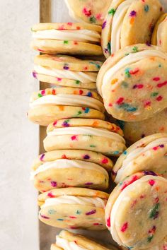 cookies with white frosting and colorful sprinkles