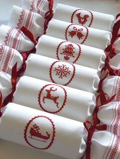 white towels with red trim and reindeer designs on them are lined up next to each other