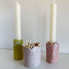 three candles are sitting next to each other