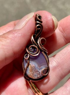 Unique Purple Agate Pendant in Square Copper Wire. Cabochon created by Monkeylion Designs. Approximately 1 5/8" long and 11/16" wide. This pendant has been antiqued, polished and sealed. Sealed with Protectaclear. ProtectaClear is a clear, protective coating that is tough enough to protect jewelry and is safe for wear against skin. ProtectaClear is practically invisible once applied and will seal and protect jewelry from tarnish, oxidation, and corrosion. Purple Agate, Agate Pendant, Copper Wire, Phone Ring, Agate, Gemstone Rings, Copper, Purple, Gemstones