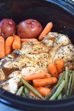 chicken, carrots and green beans in a crock pot with potatoes on the side