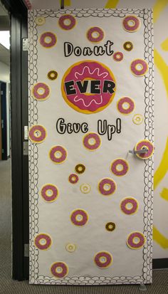 a door decorated with doughnuts and the words don't ever give up