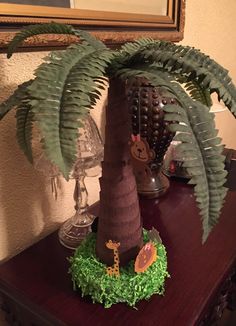 there is a fake palm tree on top of the table with other decorations around it