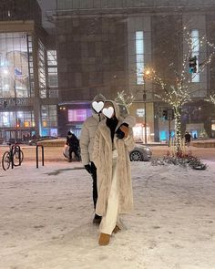 two people wearing masks walking in the snow