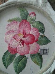 a pink flower painted on a white piece of cloth