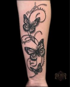 a black and white tattoo with butterflies on the leg that says, i love you