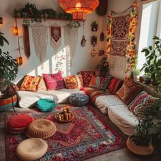 a living room filled with lots of pillows and rugs