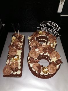 two chocolate birthday cakes with candles and decorations