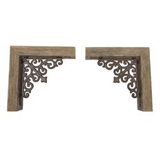 two wooden shelfs with metal brackets on each side and an ornate design at the top