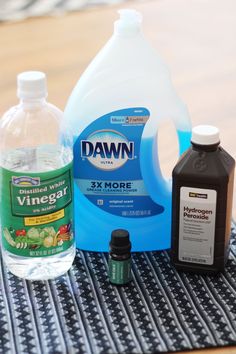 the contents of a dishwasher sitting on top of a table next to a bottle of detergent