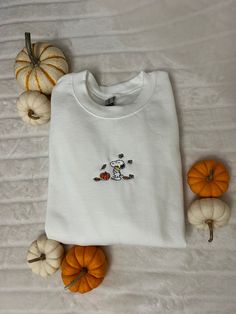 Embroidered Autumn Dog Pullover Material: 50% Cotton and 50% Polyester  Sizing Unisex: S, M, L, XL Shipping : We usually need between 1-3 days to make the product, and Worldwide shipping would usually take about 7-15 days to USA and most of countries. If you need fast shipping, we can ship via DHL/UPS, and you can receive it in about 3 to 6 days normally. Once you wash the product the film will disolve.  Please feel free to contact me with any question, We'd love to help.💞 Dog With Pumpkin, Fall Snoopy, Snoopy Fall, Snoopy Sweater, Crewneck Embroidery, Fall Embroidery Designs, Crewneck Design, Graphic Sweaters, Embroidery Sweatshirt