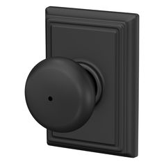 a black knob on the side of a wall