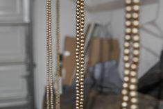 some gold beads are hanging from the ceiling