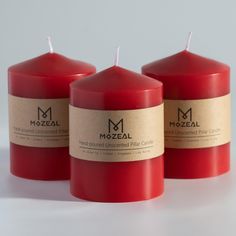 three red candles sitting next to each other