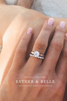 a woman's hand with a diamond ring on top of her left hand and the words estther & pelle written below it