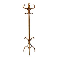 a wooden coat rack with two hooks on it's sides and an umbrella holder attached to the top