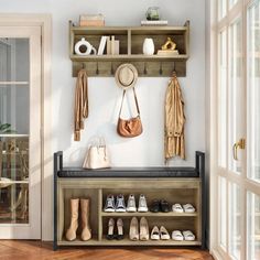 a wooden bench with shoes and hats on it in front of a white wall filled with open doors