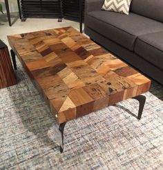 a coffee table made out of wood with metal legs