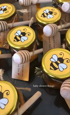 several honey jars with bees on them and tags attached to them that say baby shower things