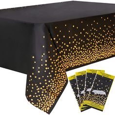 a black table cloth with gold dots on it