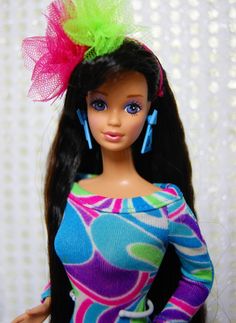 a doll with long black hair wearing a colorful dress and bright green headbands