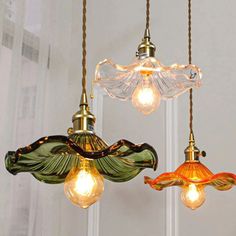 three glass lights hanging from the ceiling