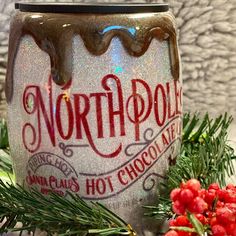 there is a frosted jar with the word north pole on it next to some christmas decorations