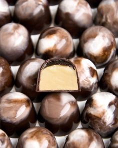 a chocolate candy with a bite taken out of it's center surrounded by other chocolates