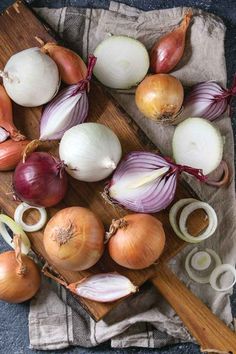 onions and garlic on a wooden cutting board