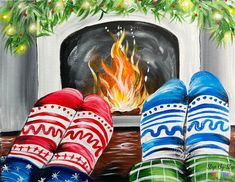 two pairs of colorful socks sitting in front of a fireplace with christmas decorations on it