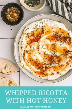 whipped ricotta with hot honey in a bowl next to two slices of baguette bread