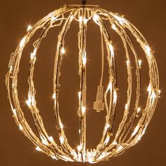 a ball with lights inside it on a brown background and some wires in the middle