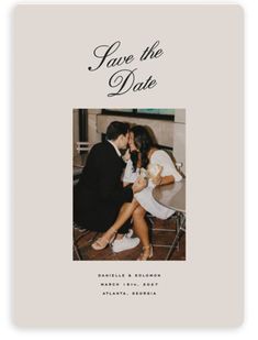 a wedding photo save the date card with an image of two people kissing and holding each other