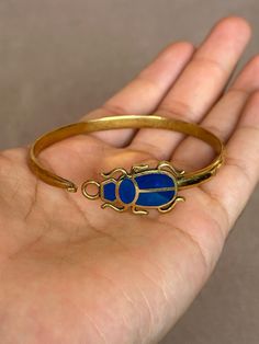 If You Can't Stop Thinking About ItBUY IT ;) The Gold Scarab Bracelet Inspired by ancient Egypt, this exquisite piece blends modern elegance with the timeless allure of the scarab beetle, a symbol of rebirth and protection. Perfect for both men and women, it's a captivating gift resonating with millennia of history and culture. Visit https://www.etsy.com/shop/egyptoriginals  for more handcrafted Ancient Egyptian Art Sculpture statues Egyptian Jewelry Modern, Egyptian Jewelry Ancient, Egyptian Jewellery, Egypt Jewelry, Ancient Egyptian Jewelry, Scarab Bracelet, Bracelet Inspired, Egyptian Scarab, Rare Jewelry