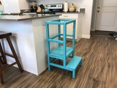 a blue step stool sitting in the middle of a kitchen