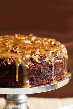 a bundt cake with pecans and caramel drizzle on top