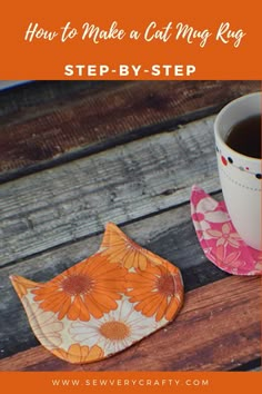 an orange and white flowered napkin next to a cup of coffee on a wooden table