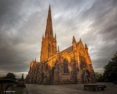 an old church with the sun shining on it's steeple and spires