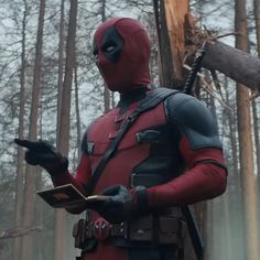 a deadpool is standing in the woods