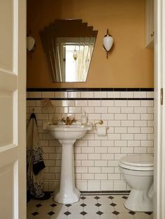 A half-tile bathroom with umber wall paint and Victorian floor tile