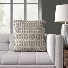 a white couch sitting next to a window in a living room