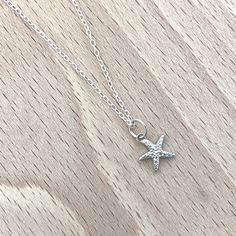 Delicate little starfish with a bobbled texture handmade from sterling silver and hung on a silver chain. Matches the starfish studs and hoops in the same size.  Dimensions (approx): Starfish (including jump ring) - 8mm x 13mm Chain - 16", 18", 20" Adjustable Sterling Silver Charm Necklaces With Star Charm, Adjustable Sterling Silver Necklace With Star Charm, Adjustable Sterling Silver Star Charm Necklace, Silver Starfish Charm Necklace In Sterling Silver, Sterling Silver Starfish Necklace With Star Charm, Ocean-inspired Sterling Silver Charm Necklaces, Sterling Silver Necklace With Starfish Charm, Star-shaped Sterling Silver Jewelry With Lobster Clasp, Ocean-inspired Silver Sterling Charm Necklaces