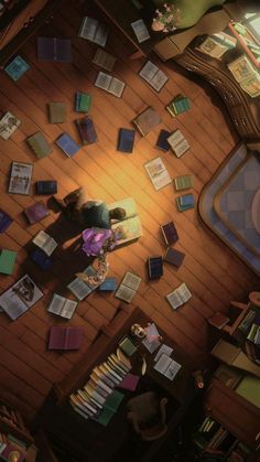 an overhead view of a living room with books scattered all over the floor