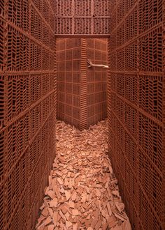 the inside of a wooden structure with lots of wood shavings on the floor