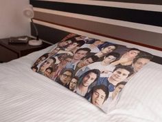 two pillows with pictures of people on them sitting on a bed in a hotel room