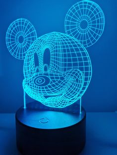 a mickey mouse lamp is shown on a blue surface with an image of the head