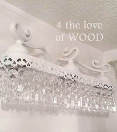 a chandelier hanging from the ceiling with words above it that read, 4 the love of wood